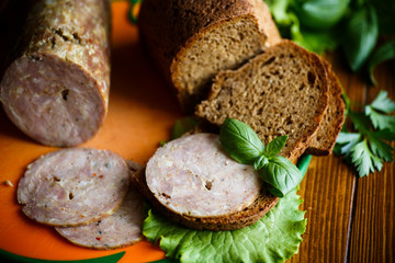 A sandwich with homemade sausage and rye bread