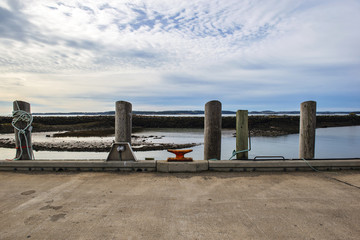Fishing docks, and piers on Deer Island, one of the Fundy Bay Islands in Canada.  Old buildings, lobster traps and buoys fill the piers and docks.