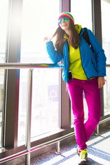 Myanmar. Woman, blue jacket, hat rainbow, sunglasses, pink jeans