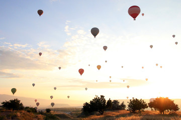 Travel to Goreme, Cappadocia, Turkey. The sunrise in the mountains with a lot of air hot balloons in the sky.