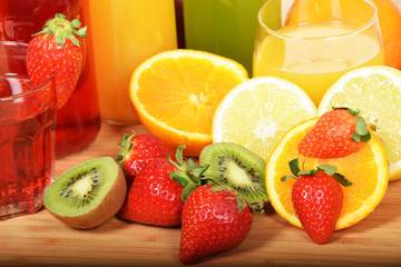Fototapeta na wymiar A glass of cold orange juice and strawberries