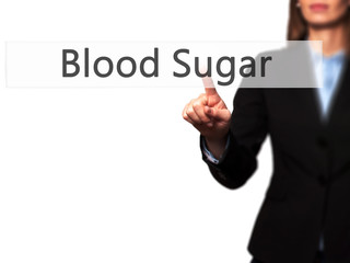 Blood Sugar - Businesswoman hand pressing button on touch screen interface.