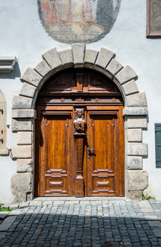 Ancient wooden door in an ancient medieval house. Ancient city architecture of Europe
