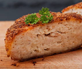 Chicken cutlet on an old wooden background, food.