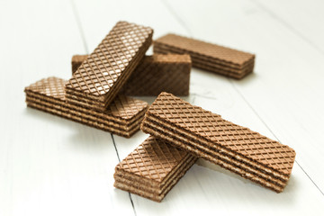 A slice of chocolate wafers on a white table, a snack.