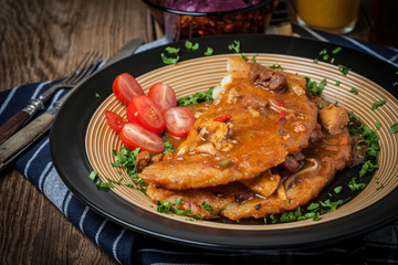 Potato pancakes with meat stew served on a plate.