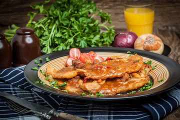 Potato pancakes with meat, vegetable, tomato and parsley.
