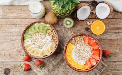 Granola with Greek yoghurt and fruit on a wooden background in a rustic style