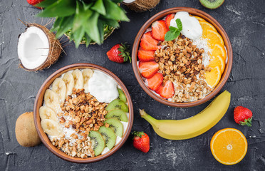Granola with Greek yoghurt and fruit on a wooden background in a rustic style