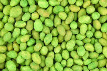 Closeup of peanuts in green wasabi with salt for background