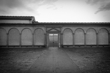 Certosa di Galluzzo di Firenze entrance, inner courtyard. Italy. Photo in black and white color style. Vignette effect.