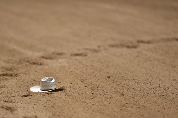 Cowboy hat on the sand