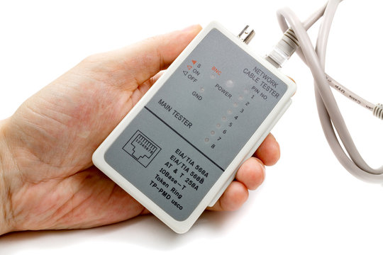 Network cable tester in man's hand and UTP cable on a white background
