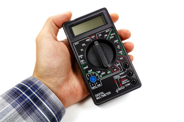 Digital multimeter in man's hand on a white background