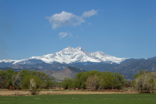 Fototapeta Snow capped Longs Peak and Mt Meeker on a spring or summer day
