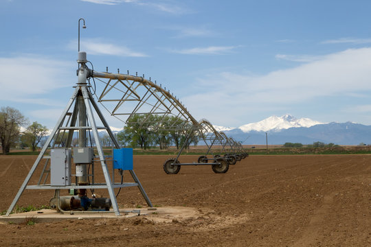 Pivot Irrigation System in a farming field with Longs Peak Mountain in the background