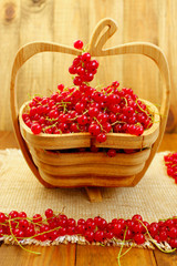fresh red currant on the wooden vase