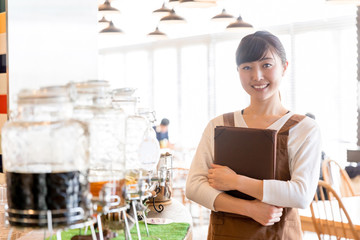 portrait of young asian waitress in cafe