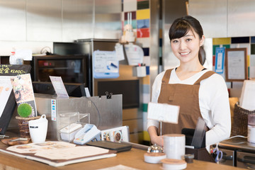 portrait of young asian waitress in cafe