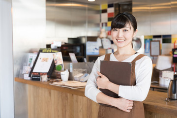 portrait of young asian waitress in cafe