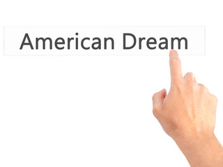 American Dream - Hand pressing a button on blurred background concept on visual screen.