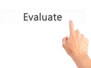 Evaluate - Hand pressing a button on blurred background concept on visual screen.