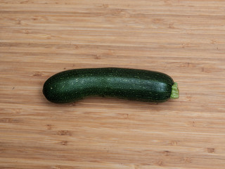 Single Zucchini / Green Squash on cutting board