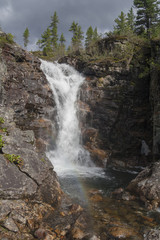 Fototapeta na wymiar Waterfall in the mountains of Khamar-Daban