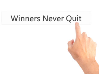 Winners Never Quit - Hand pressing a button on blurred background concept on visual screen.