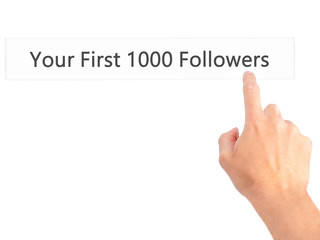 Your First 1000 Followers - Hand pressing a button on blurred background concept on visual screen.