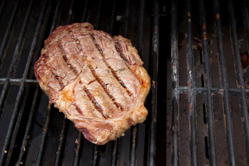 Ribeye Steak grilling on a Barbecue