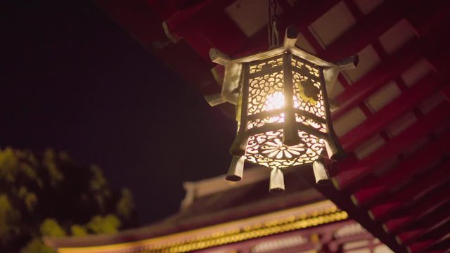 Japanese traditional lantern illuminated at night
