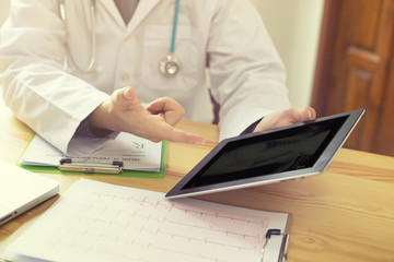 Doctor shows results to old patients x-ray of the lungs, smoking a cigarettes problem with tablets,Health Check with digital system support patient,test results registration,medical technology concept