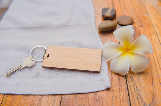 Wooden key chain on wood table .