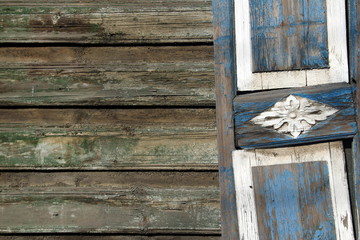 Wooden old gray wall with decorations in traditional Russian ornament