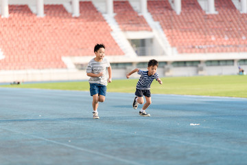 Fototapeta premium Boy running on the blue track