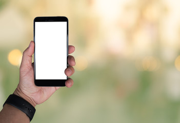 blank screen smart phone in hand with blurred background with bokeh and green filter