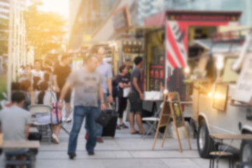 Abstract blurred background customer looking menu by food trucks carnival.