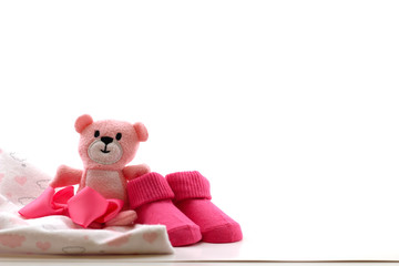 A photo of assorted baby girl items isolated on a white background