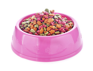 dry dog food in pink bowl isolated on white