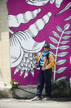 Asian thai woman travel and posing with street art at Song Wat Road in Bangkok