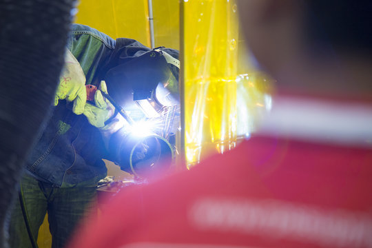 The craftsman welding the metal tube  .Hi-technology manufacturing concept