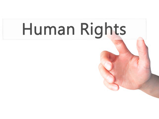 Human Rights - Hand pressing a button on blurred background concept on visual screen.