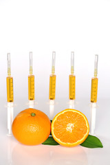 Serum with vitamin C. Five syringes with Vitamin C and orange in a section on a light background. Health and Beauty Concept