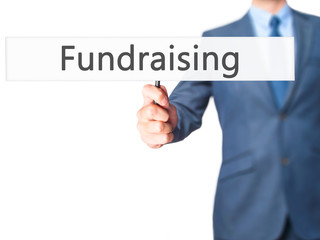 Fundraising - Businessman hand holding sign