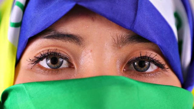 Video footage of a young muslim woman wearing headscarf of Brazilian flag