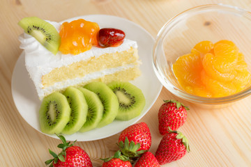 closeup delicious fresh dessert strawberry orange kiwi fruit with  white cream slice cake