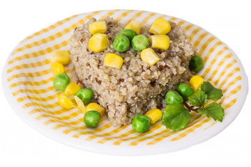 Quinoa salad with corn and green peas on plate isolated on white