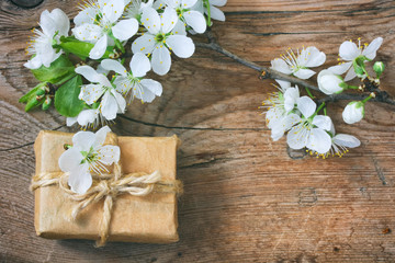 Gift box and a branch of blossoming plum