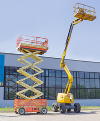 Scissor and articulated boom wheeled lifts on asphalt ground © An-T